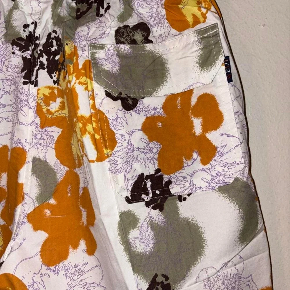 Swim Shorts Orange, black, and purple floral print swim trunks #swimwear #floral